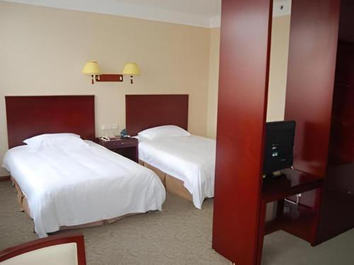 Ένα ή περισσότερα κρεβάτια σε δωμάτιο στο GreenTree Inn Zibo Renmin Park