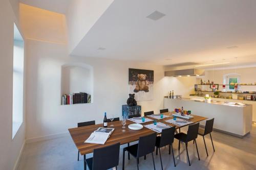 a dining room with a large wooden table and chairs at B&B Opus35 in Montzen