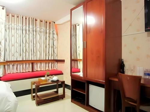 a room with a red bench and a table at An Dong Center Hotel Chinatown Saigon in Ho Chi Minh City