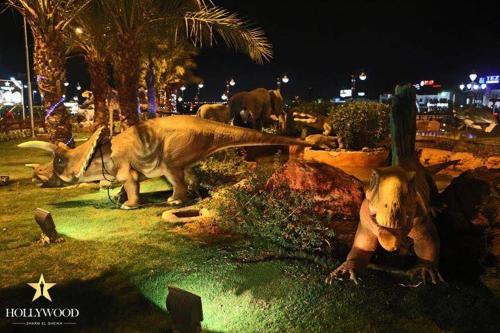 a group of dinosaurs laying on the grass at night at Hollywood Aqua Park Sharm El-Sheikh in Sharm El Sheikh