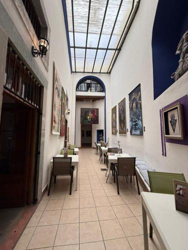 a dining room with tables and chairs and a ceiling at la casa positos in Guanajuato