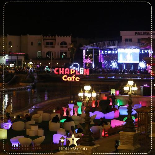 a city lit up at night with a chandan cafe at Hollywood Aqua Park Sharm El-Sheikh in Sharm El Sheikh