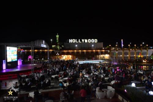 a crowd of people sitting at tables in front of a building at Hollywood Aqua Park Sharm El-Sheikh in Sharm El Sheikh