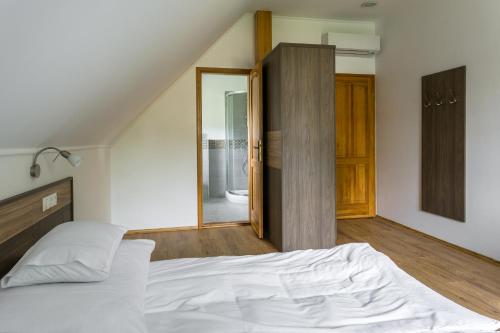 a bedroom with a bed and a sliding glass door at Figula Vendégház in Balatonfüred