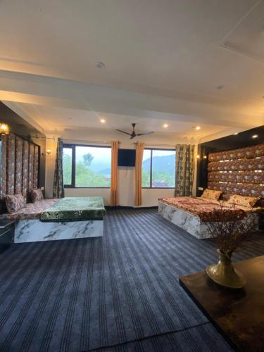 a bedroom with two beds and a large window at Lake side stays in Srinagar