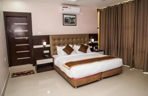 a bedroom with a large bed in a room at Hotel Gajur Palace in Itahari