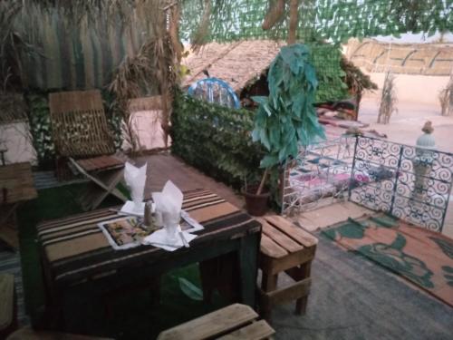 a living room with a couch and a table at Dar alibaba in Douz