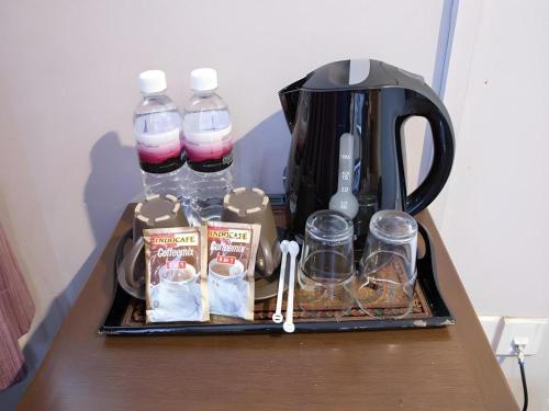a tray with bottles of water and other items on a table at Hotel 165 in Singapore