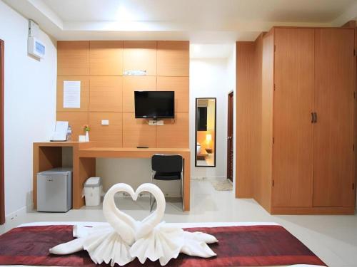 a room with a heart decoration on a bed at Phakawan Hotel in Maha Sarakham