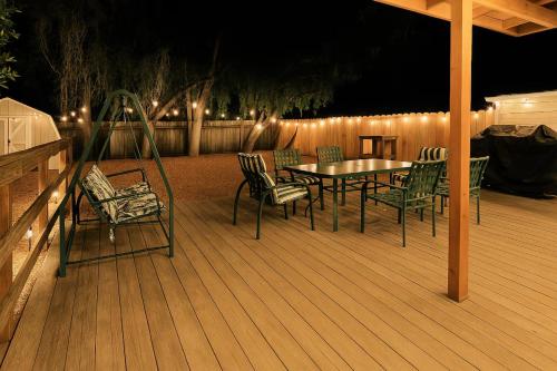 a table and chairs on a deck at night at Long stay Google BBQ BIG yard in Mountain View