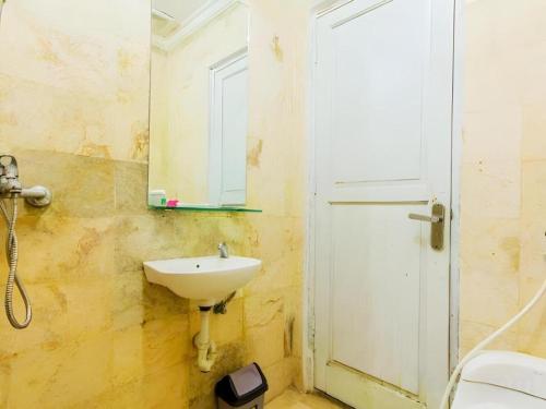 a bathroom with a sink and a mirror at Albis Hotel in Bandung