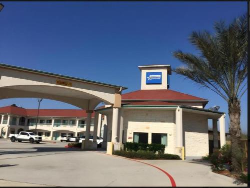 a large building with a sign on top of it at Americas Best Value Inn and Suites IAH Airport North in Houston