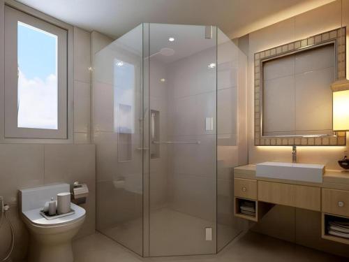 a bathroom with a shower and a toilet and a sink at HW Hotel Padang in Kampungdurian