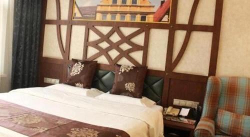 a bed with a wooden headboard in a room at Zaozhuang Hotel in Zaozhuang
