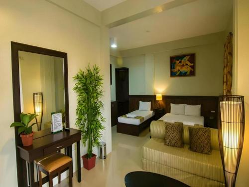 a hotel room with a bed and a couch at Driggs Pension House in General Santos