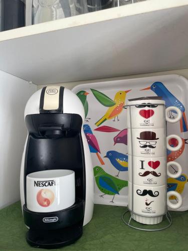 a black and white coffee maker sitting on a shelf at Villa Mandarin in Opuzen