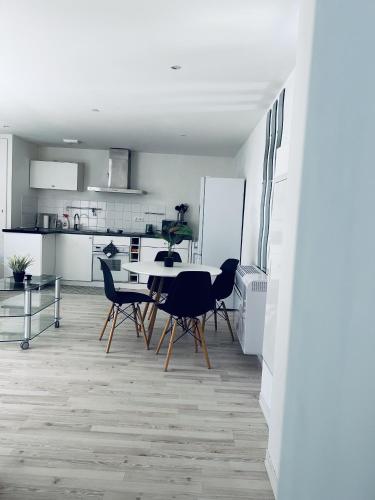 a kitchen and dining room with a table and chairs at Petit coin tranquille a 2 pas de strasbourg in Strasbourg