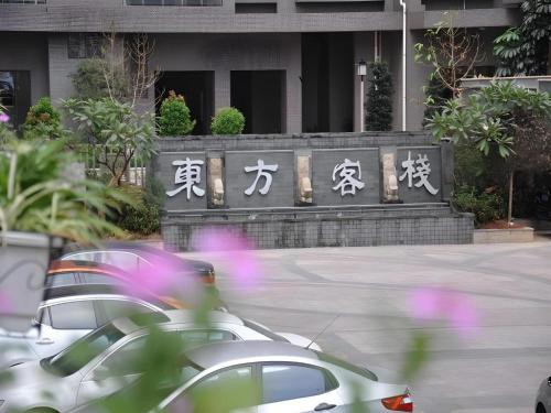 a car parked in front of a building with asian writing at Oriental Hotel in Dongguan