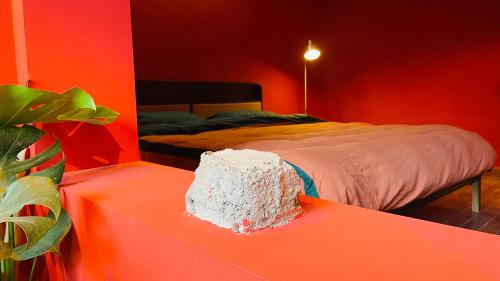 a red bedroom with a bed and a table at The house where time is wasted under the road in Chongqing
