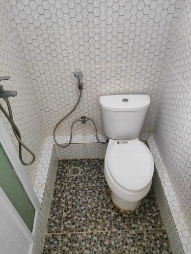 a bathroom with a toilet and a shower at Lawang Rinjani in Sembalun Lawang