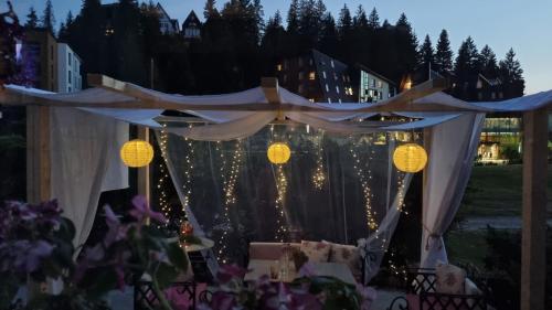 Una mesa preparada para una boda de noche con luces. en Enjoy the Silence Holiday Home, en Vlašić