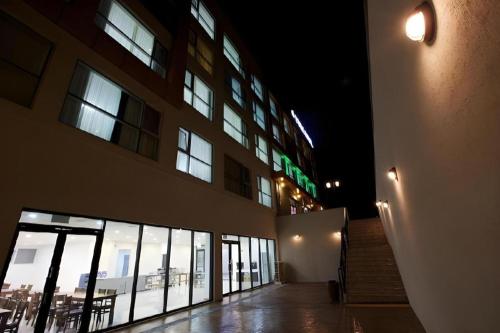 a building at night with a bunch of windows at Ewha Hotel in Jeju