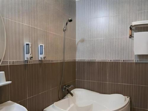 a bathroom with a shower and a toilet and a sink at Mi Linh Hotel in Ho Chi Minh City