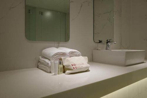 a bathroom with a sink and towels on a counter at Bobo Hotel Hongdae in Seoul