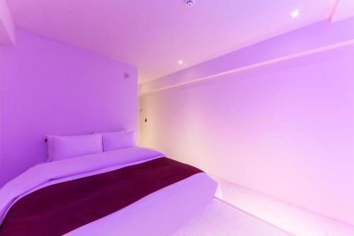 a purple bedroom with a bed in a room at Bobo Hotel Hongdae in Seoul