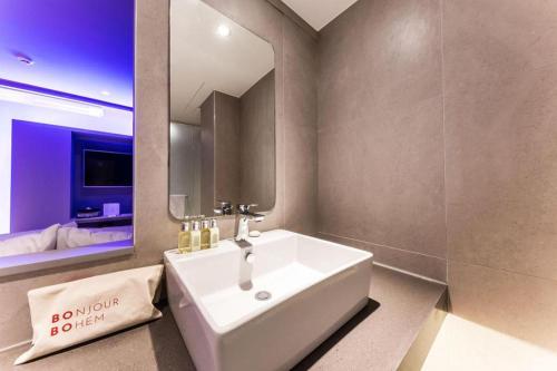 a bathroom with a white sink and a mirror at Bobo Hotel Hongdae in Seoul