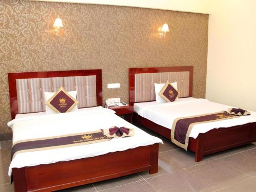 Postel nebo postele na pokoji v ubytování Tran Vinh Hotel
