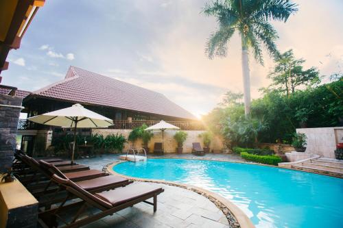 a swimming pool with lounge chairs and a resort at Deluxe Glamping in Mai Chau Lodge in Mai Chau