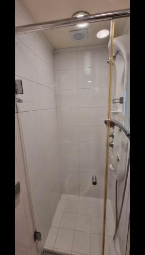 a shower with a glass door in a bathroom at Hongdae Sinchon Skyview in Seoul