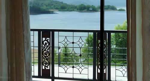 a view of a lake from a window at Rim Kaeng resort in Phetchaburi