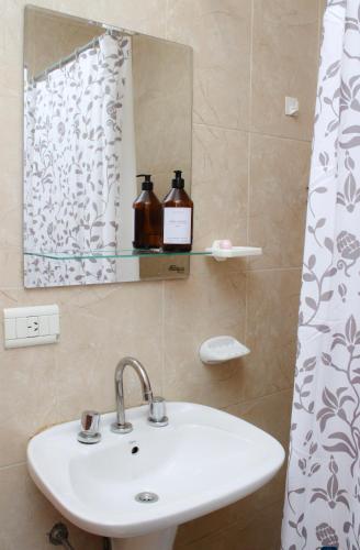 a bathroom with a sink and a mirror at VL Apart in Villa Regina
