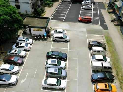a bunch of cars parked in a parking lot at JTOUR Inn Guilin Two Rivers and Four Lakes Walmart in Guilin