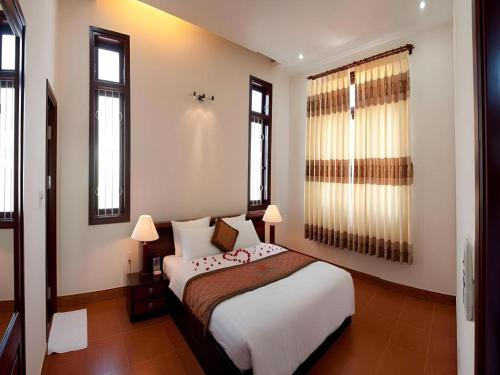 Un ou plusieurs lits dans un hébergement de l'établissement Sao Mai Phu My Resort