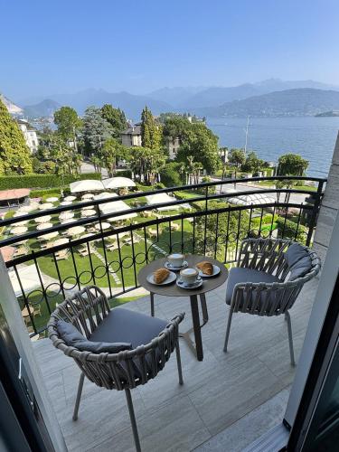 a balcony with two chairs and a table and chairs at Grand Hotel Bristol in Stresa