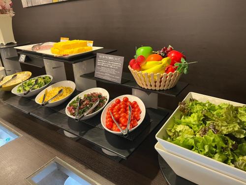 a buffet with different types of food on display at Hotel Route Inn Grand Wakayama Eki Higashiguchi in Wakayama