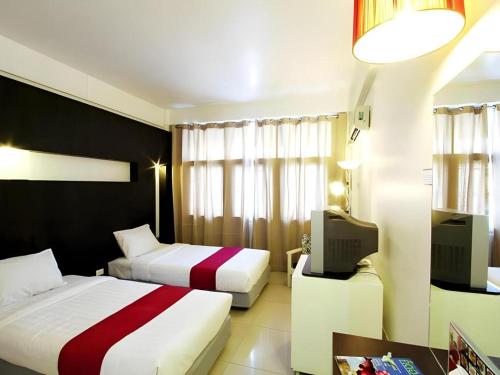 Postel nebo postele na pokoji v ubytování The Ratchathani Hotel