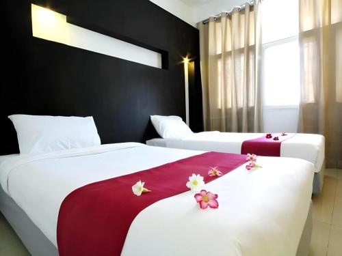 Postel nebo postele na pokoji v ubytování The Ratchathani Hotel