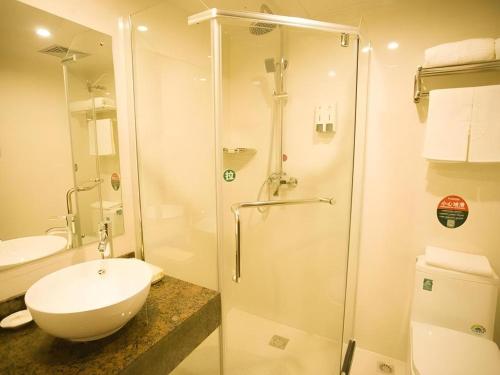 a bathroom with a shower and a toilet and a sink at GreenTree Inn Nanjing Forestry University National Exhibition Center Express Hotel in Nanjing
