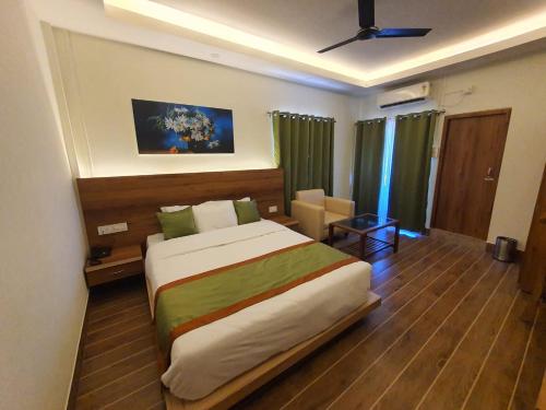 a bedroom with a large bed in a room at HOTEL DEO VOLENTE in Sivasagar