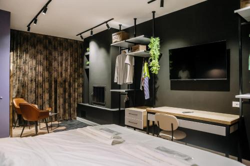 a bedroom with a bed and a desk and chairs at Karma Chic&Style Intera Villa in Korçë