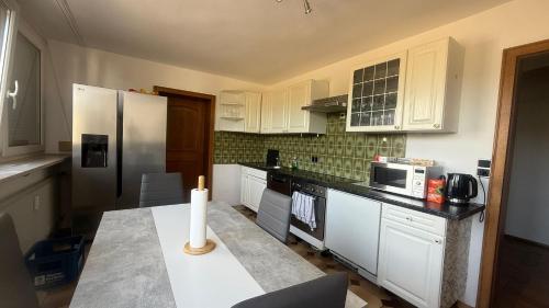 a kitchen with white cabinets and a candle on a counter at Wohnung Münchnerstrasse 54 Simbach am Inn Mü54 1 gross in Simbach am Inn