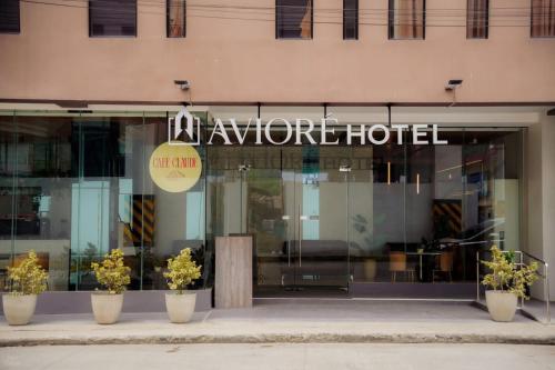 a store front of a hotel with potted plants in front at Avioré Hotel Tacloban in Tacloban