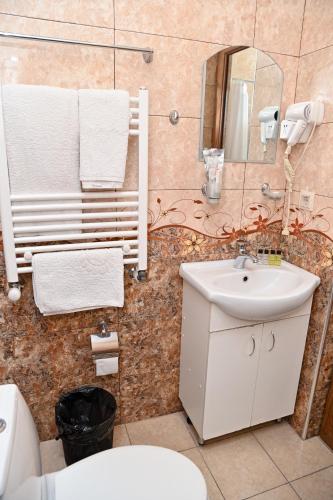 a bathroom with a white sink and a mirror at Har-Mar Hotel in Goris