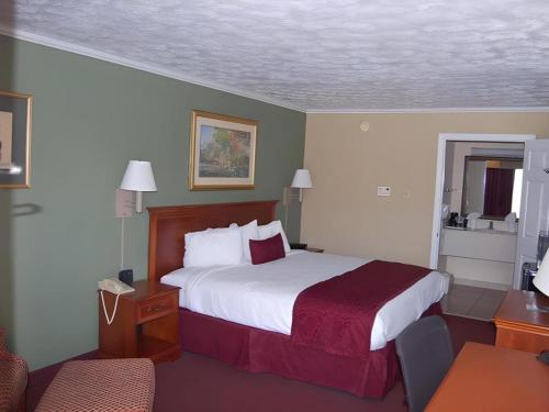 a hotel room with a bed and a chair at Best Western Athens in Athens