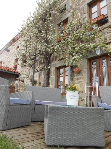 a group of wicker chairs sitting on a patio at Chambre D'hôtes Myrtille in Usson-en-Forez