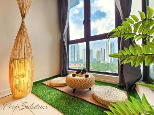 a room with a window with a table and straw hats at Spacious Cozy Elysia Suite Johor Bahru Legoland in Iskandar Puteri
